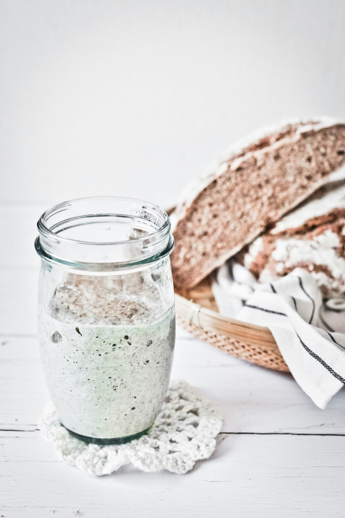 sourdough starter in glass jar fermenting for homemade brea