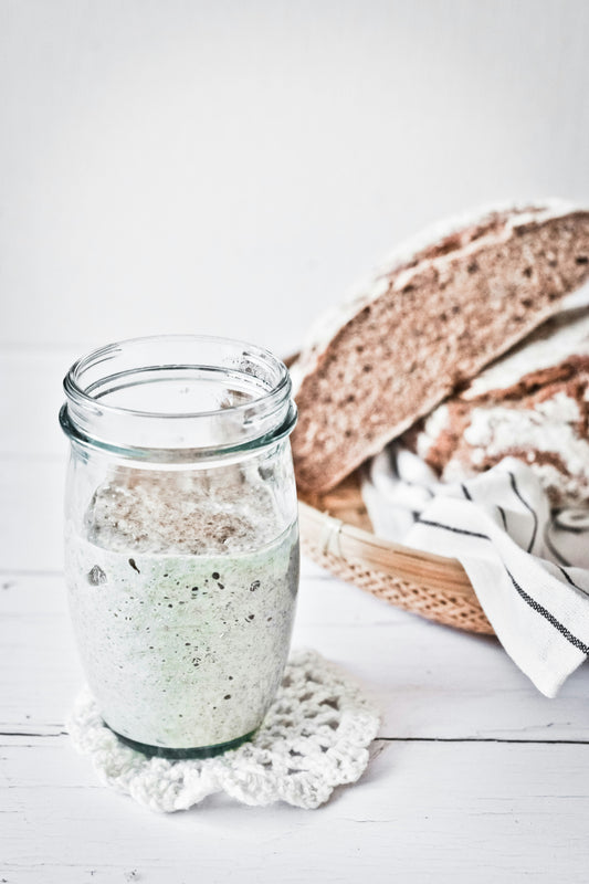 sourdough starter in glass jar fermenting for homemade brea