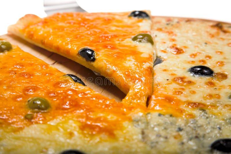 Homemade four cheese pizza with melted mozzarella, cheddar, parmesan and creamy cheese baked golden in oven