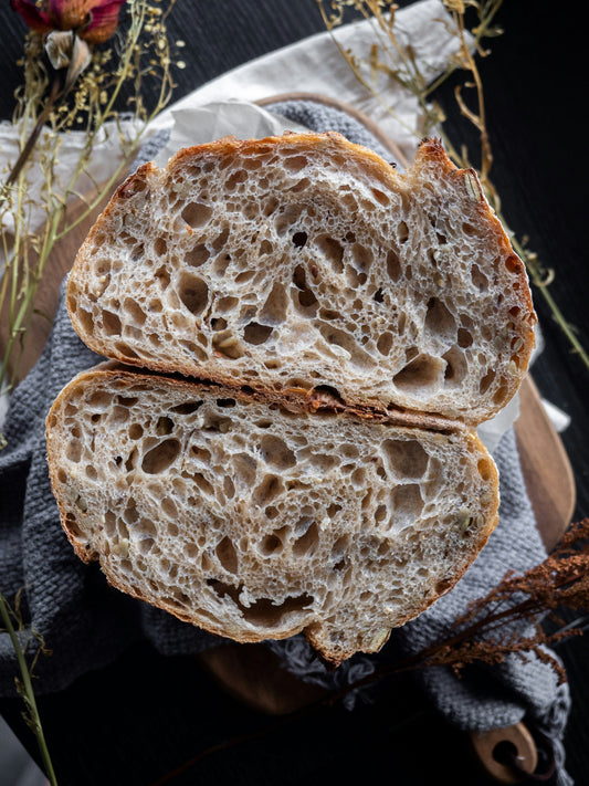 freshly baked sourdough bread with crispy crust on parchment paper homemade artisan bread