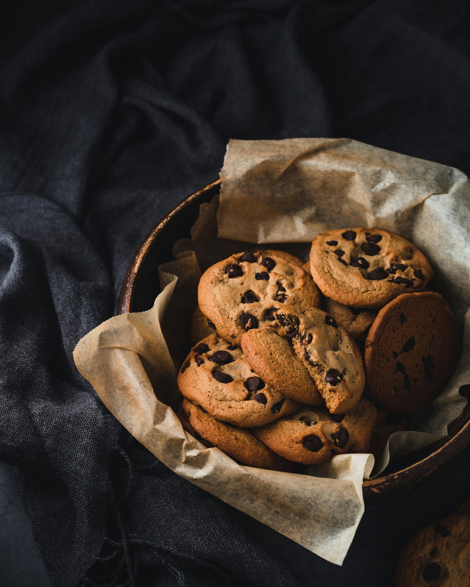 Assorted cookies and baking tools on a warm wooden kitchen background for pastry and dessert baking