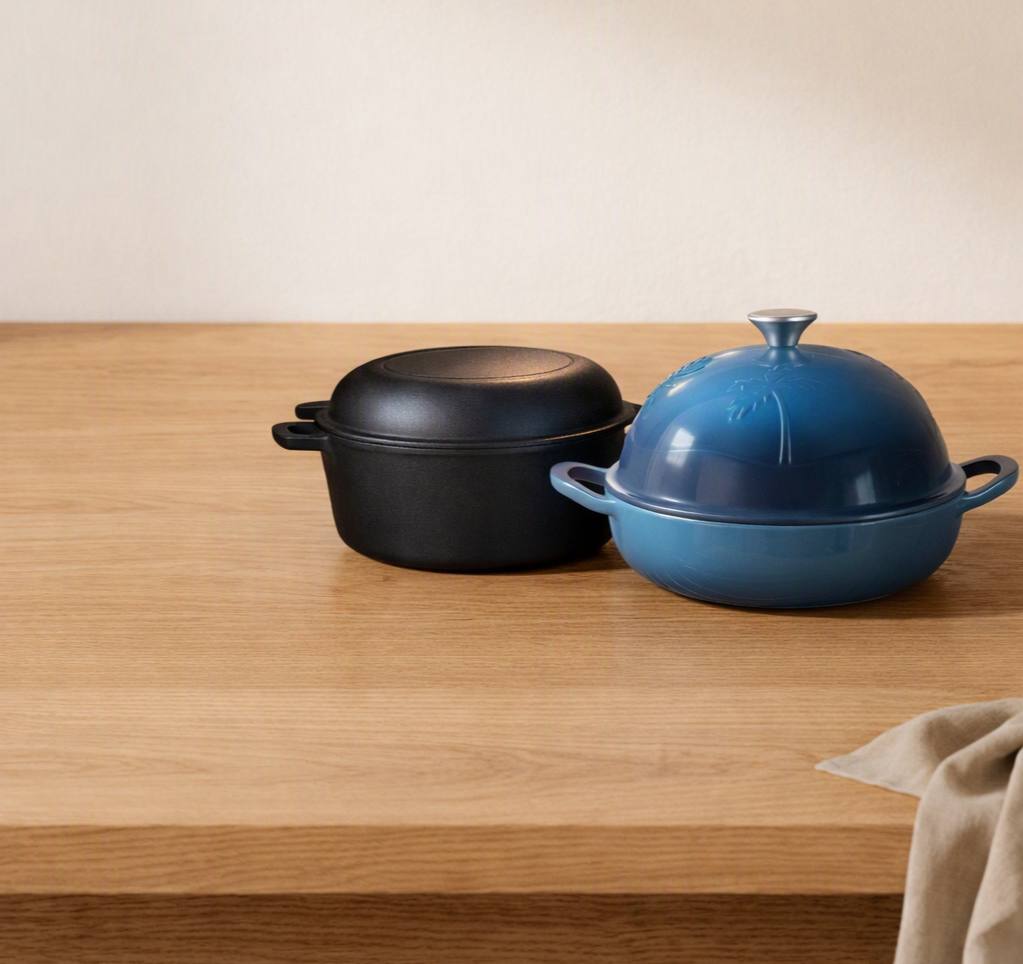 Cast iron Dutch ovens displayed on a wooden countertop